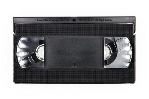 Front side of a old vhs videocassette, analog retro video tape isolated on white background, topview