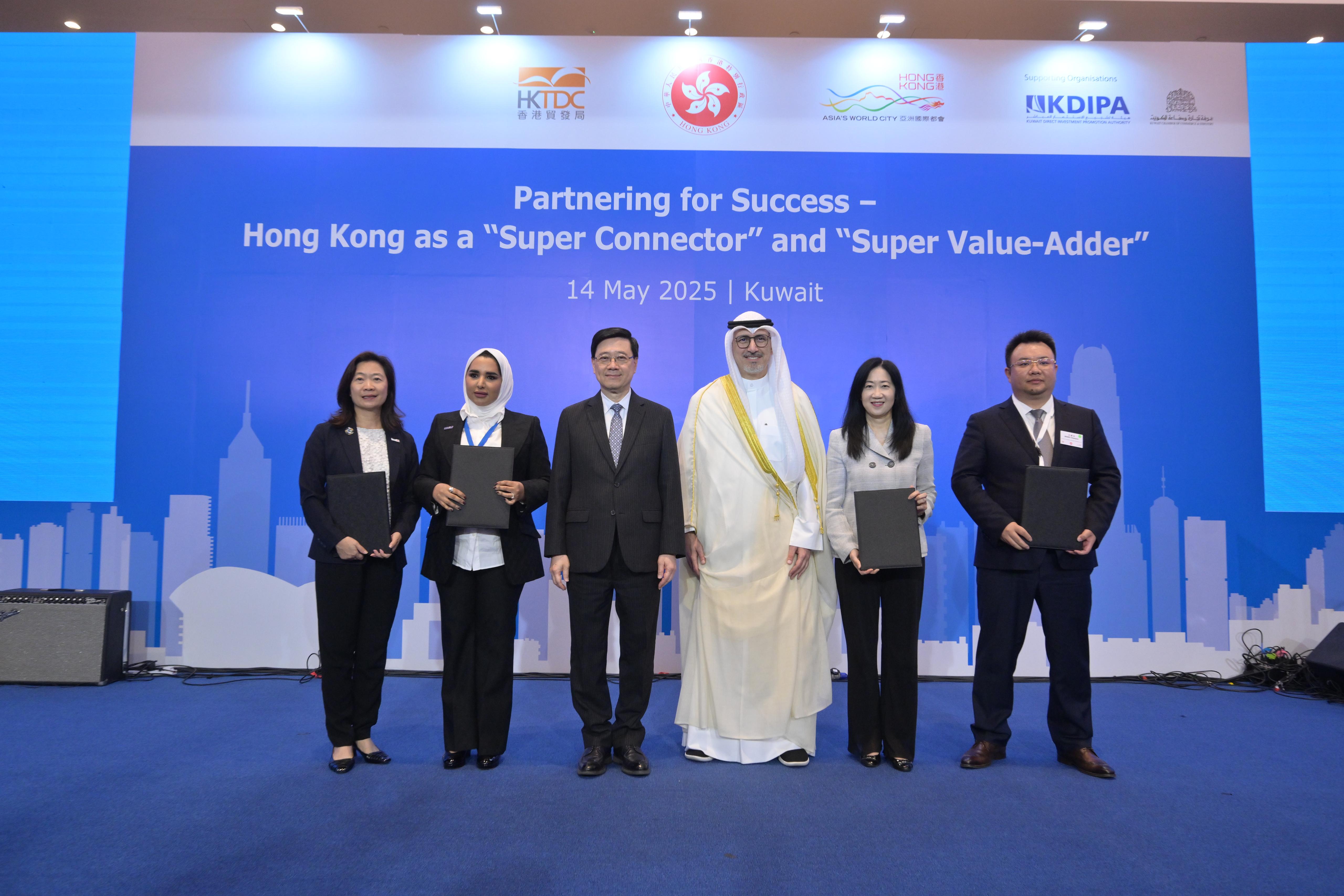 HKSAR's Chief Executive John Lee (third left) witnesses exchange of agreements reached between government departments, enterprises, and institutions from Hong Kong, Mainland China and Kuwait.