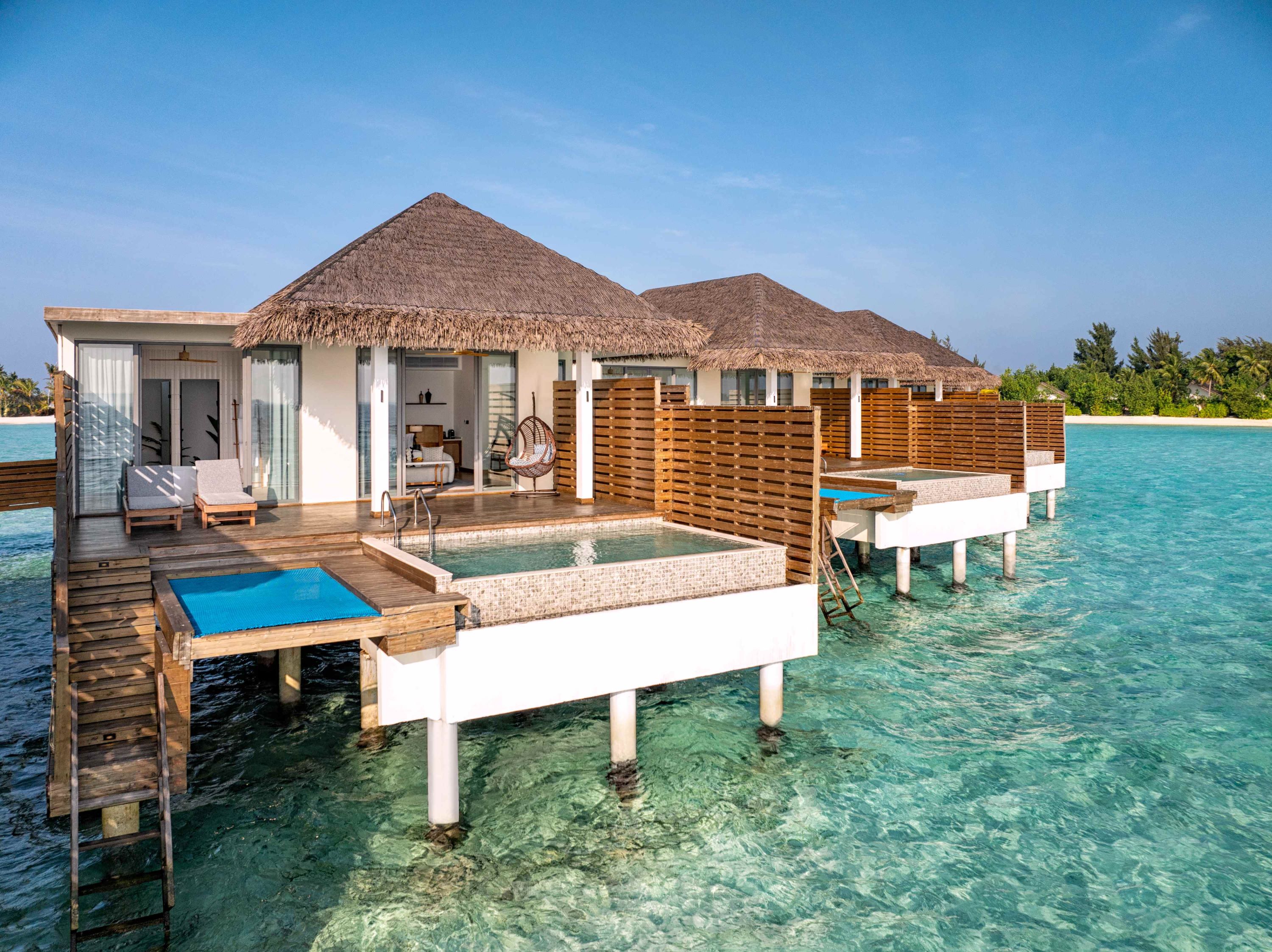 The resort’s overwater villas are thoughtfully designed for modern comfort and privacy, offering seamless indoor-outdoor living, spacious decks, and inviting plunge pools.
