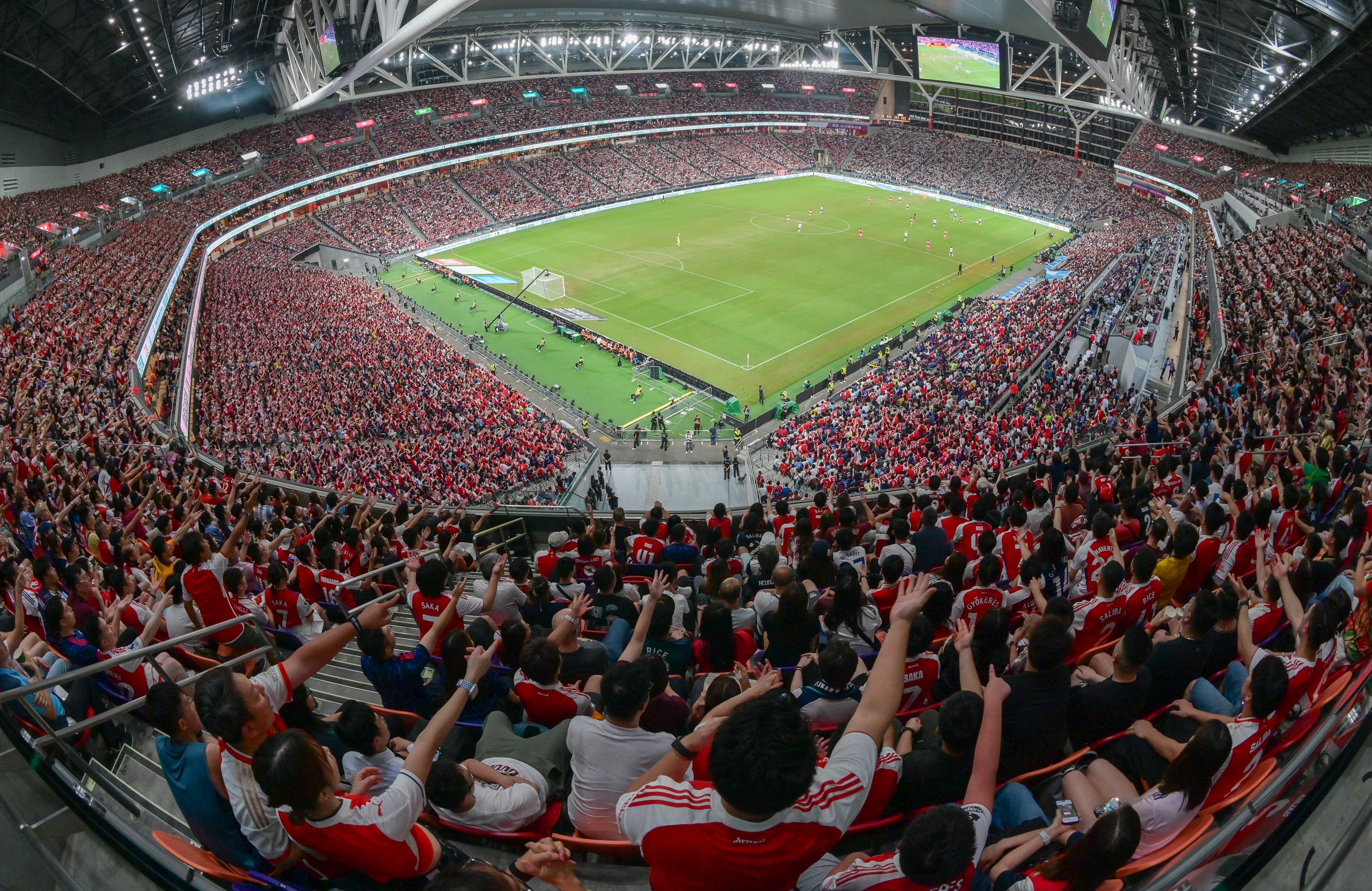 A near capacity crowd watches Arsenal take on Tottenham Hotspur at the 50,000-seat Kai Tak Stadium (July 31)