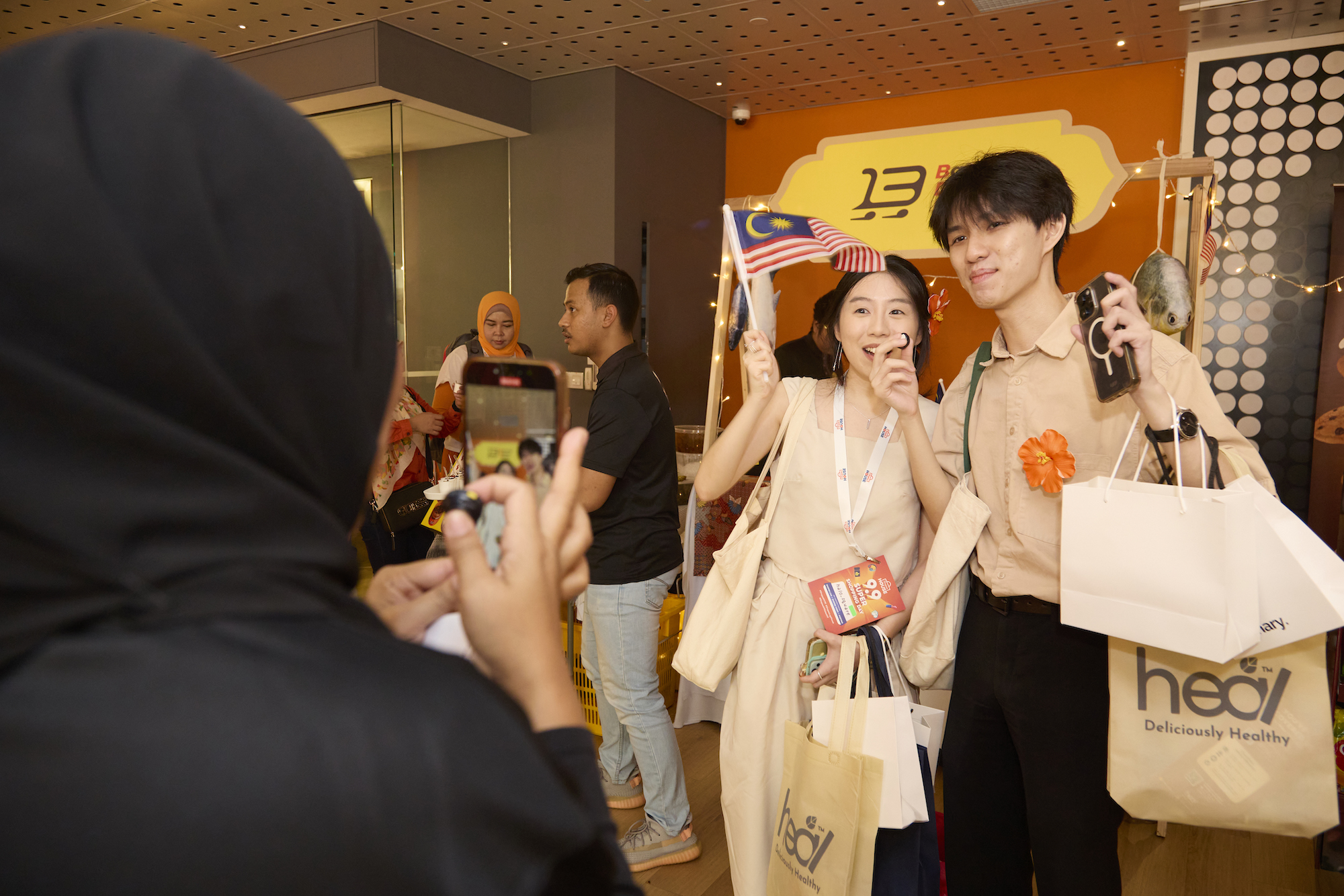 Affiliates wave the Malaysian national flag at Shopee House.