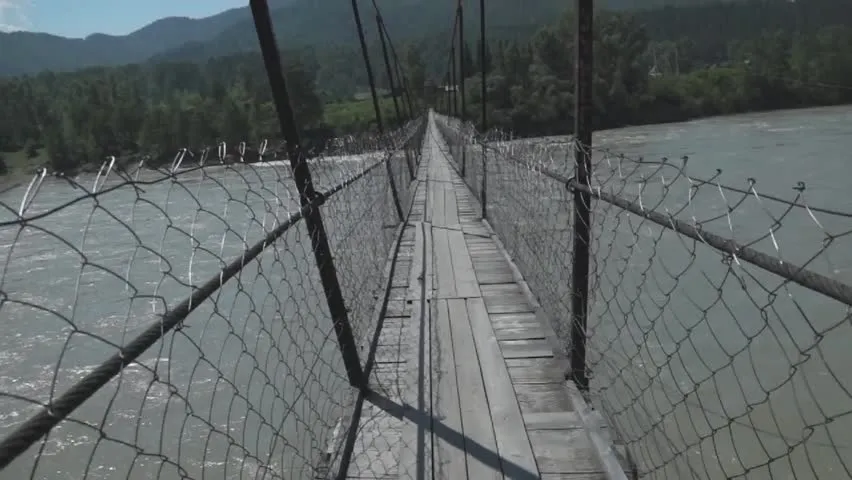 man was walking on a shaking bridge
