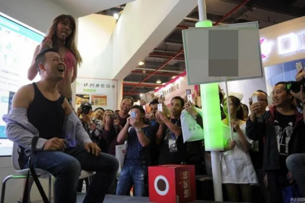 Model Feeds Guy Milk Straight From Her Mouth At Guangzhou Sex Culture Festival